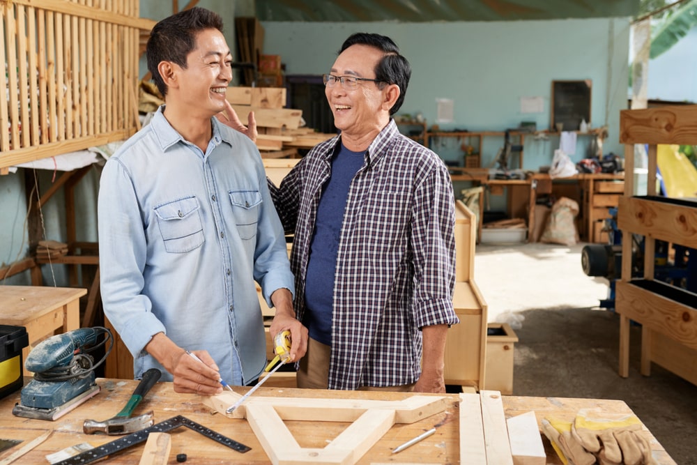 two woodworkers laughing