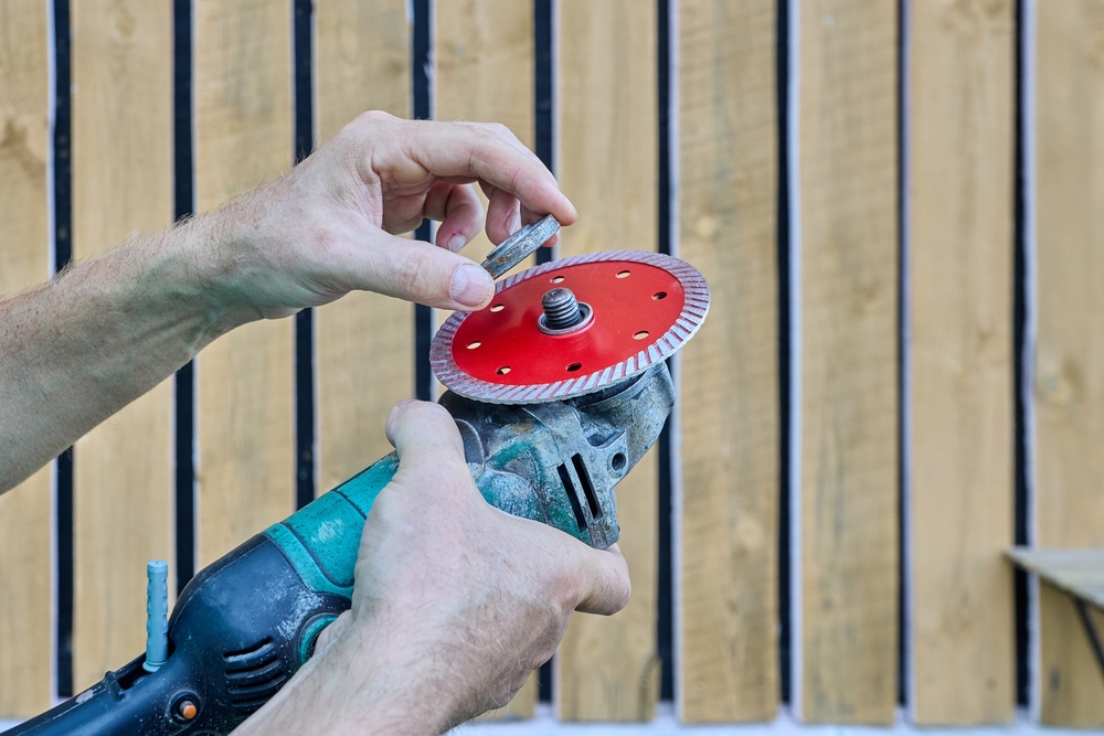 a worker assembling a grinder with a cutting disc