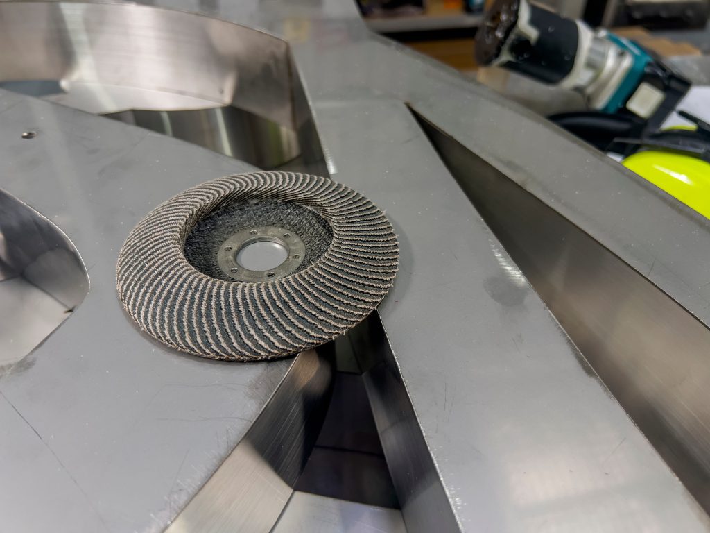 flap disc on polished stainless steel letters