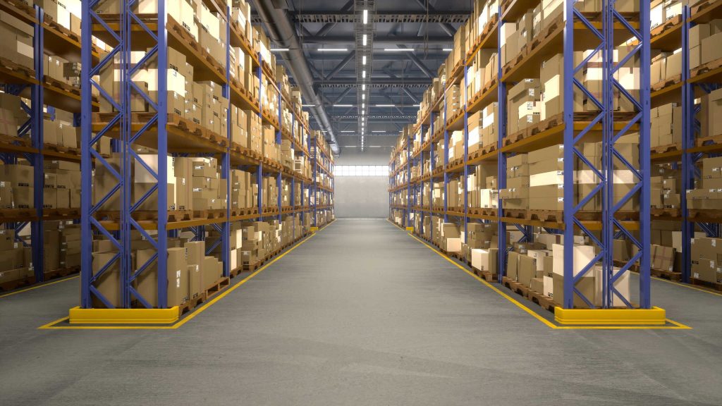 Symmetrical view down a clean, spacious warehouse aisle lined with tall blue industrial pallet racking stacked with cardboard boxes